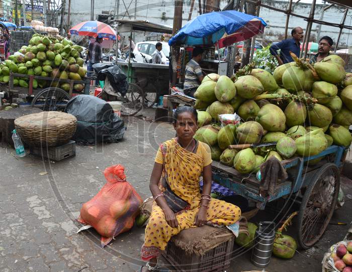 An Old Woman Selling Coconuts in Guwahati, Assam