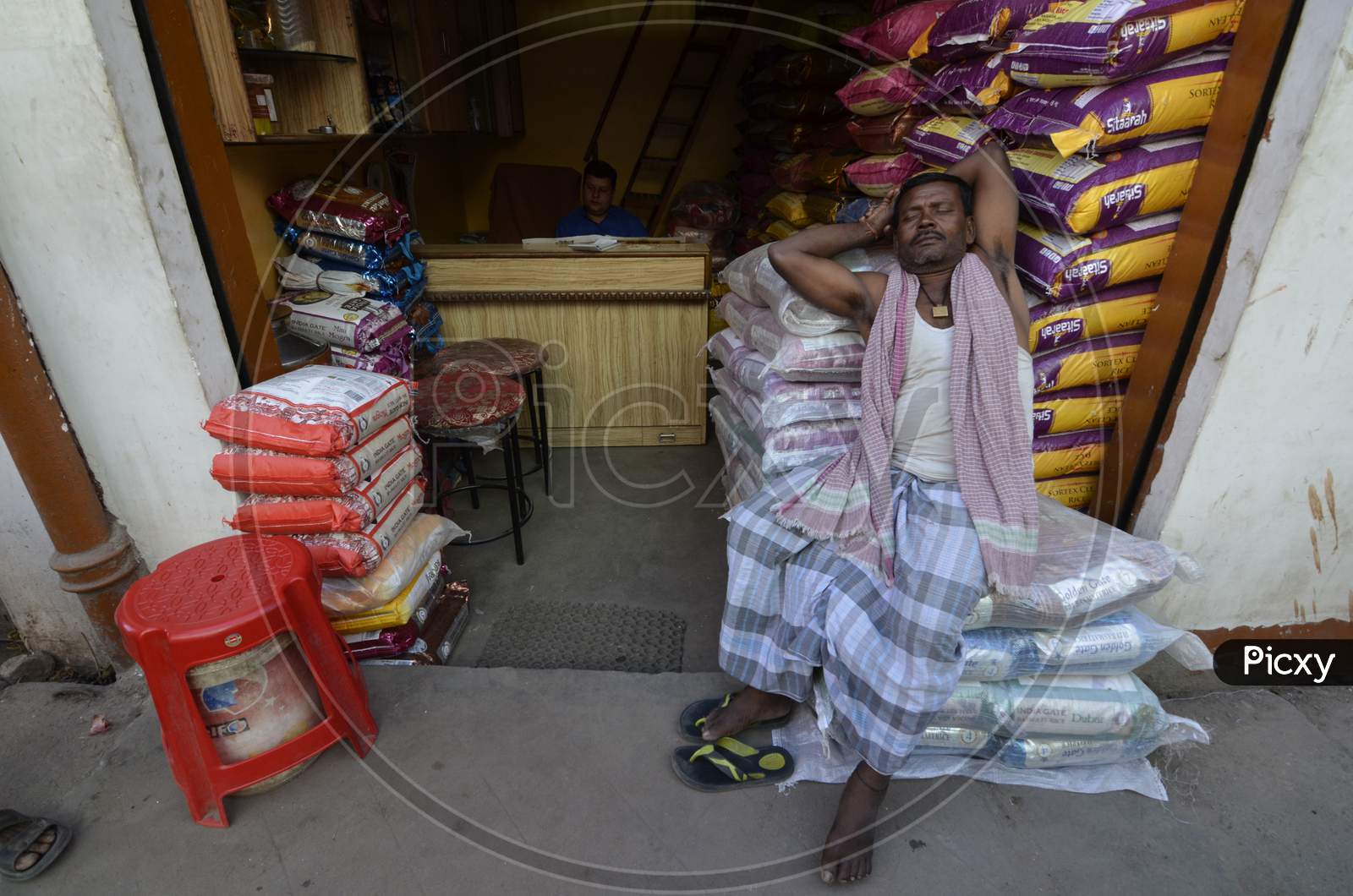 Vendors At Guwahati Bazaar Or Fancy Market  in Shops  With Goods Bags