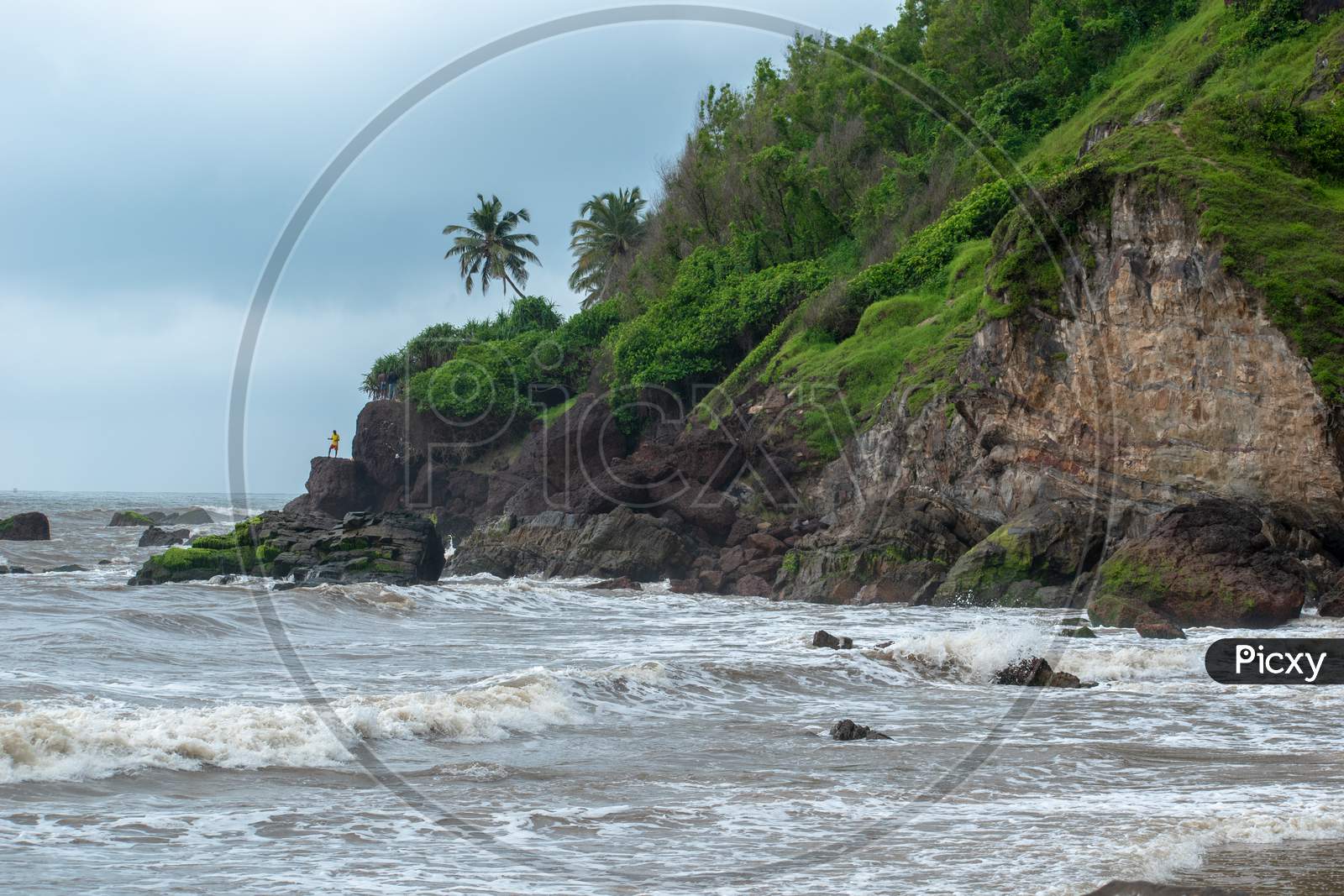 Rock Beach In Goa With Sea Waves Striking The Rocks