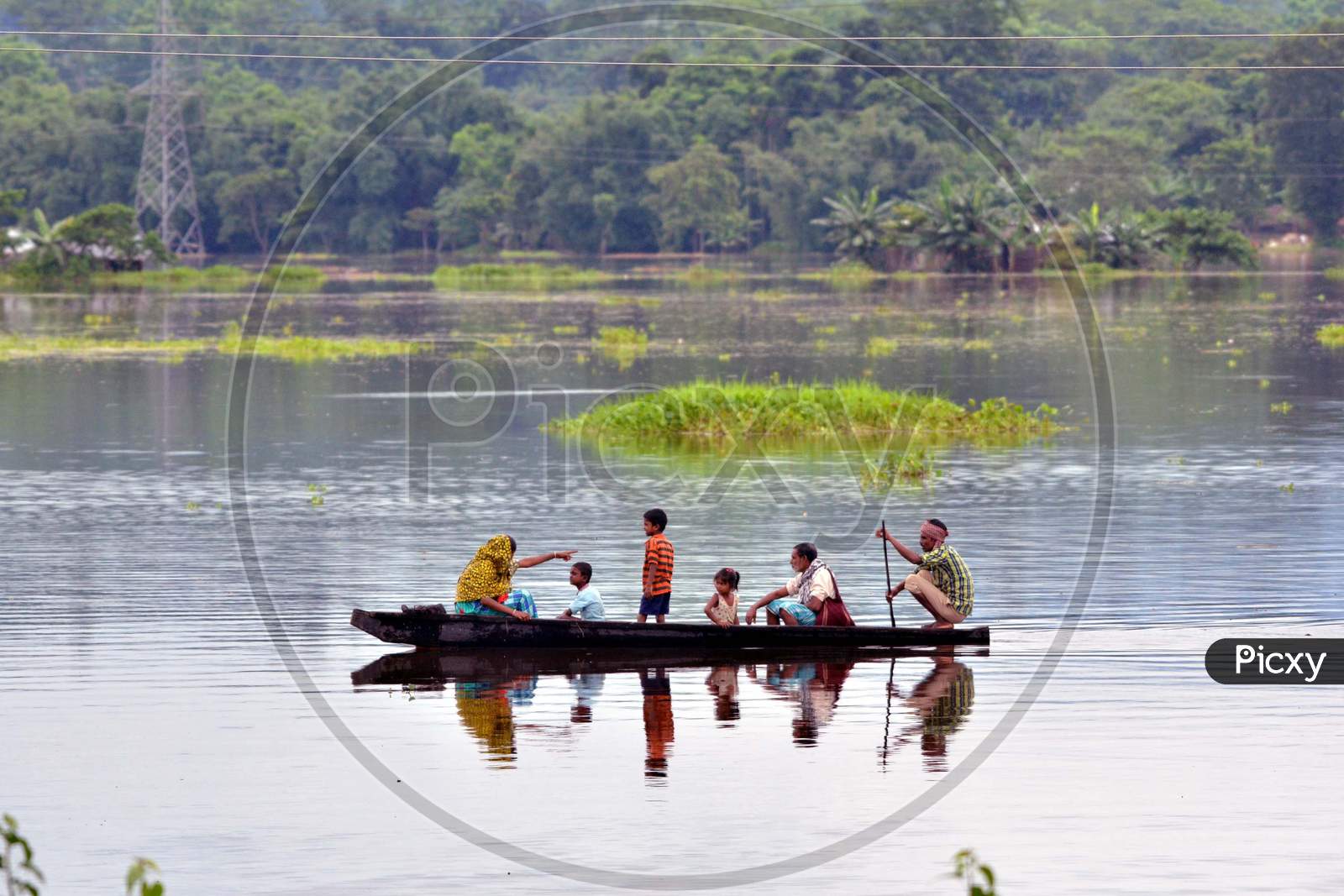 Villagers Uses A Boat Near Submerged Houses In A Village Near Kaziranga National Park In Golaghat District Of Assam On July 26,2016