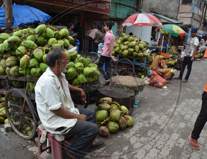 An Old Man Selling Coconuts in Guwahati, Assam