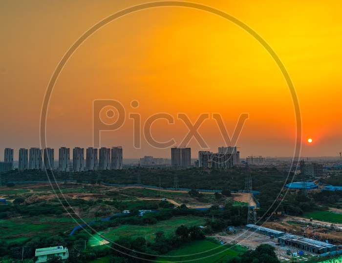 Sunset Sky Over City Scape With High Rise Buildings From  Kajaguda Hills