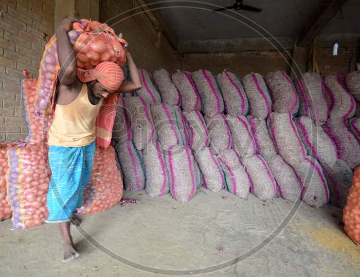 Daily Labor Workers Carrying Onion Bags  in an Onion Storage House With Onion Bags in Nagaon, Assam