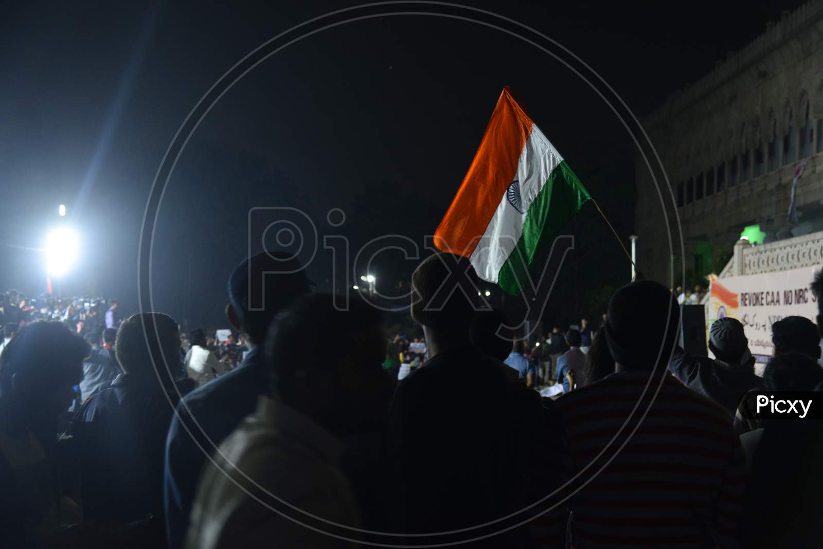 Protesters hold Indian National Flag  at a protest against CAA and NRC at Osmania Arts College