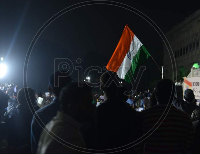 Protesters hold Indian National Flag  at a protest against CAA and NRC at Osmania Arts College