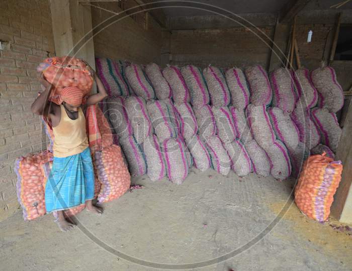 Daily Labor Workers Carrying Onion Bags  in an Onion Storage House With Onion Bags in Nagaon, Assam