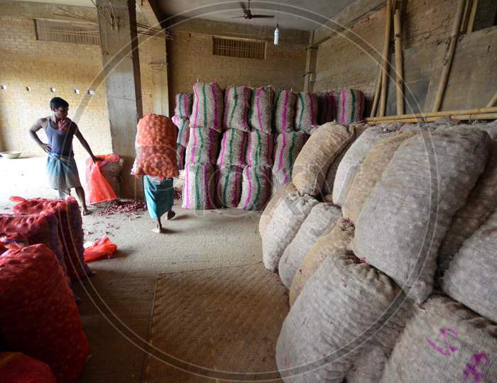 Indian Laborers Unloading Potato  Sacks At  At A   Wholesale Market In Nagaon Some Of 180Km East Of Guwahati , India July 14, 2014