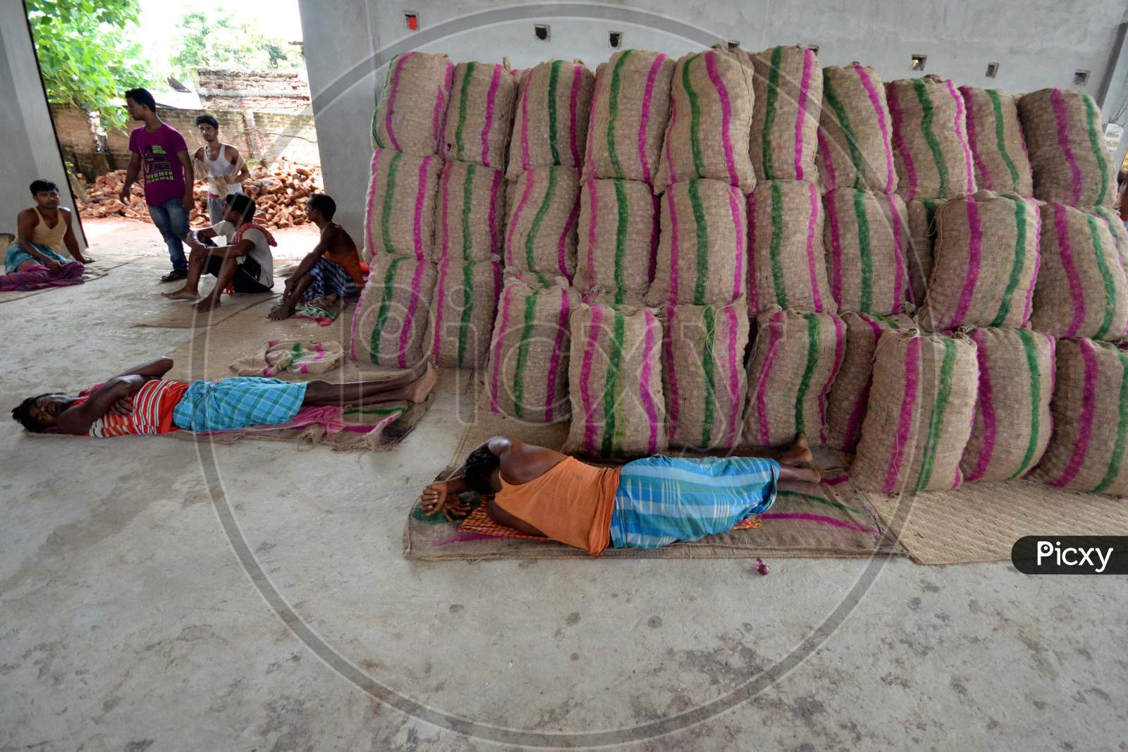 Daily Labor Workers in an Onion Storage House With Onion Bags in Nagaon, Assam