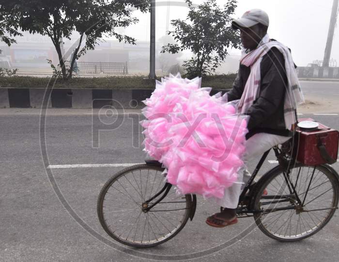 A Cotton Candy Vendor On an Bicycle on an Foggy Winter Morning in Guwahati