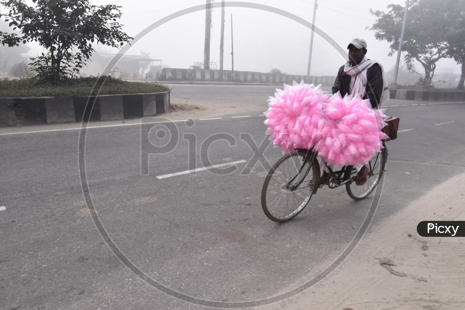 A Cotton Candy Vendor On an Bicycle on an Foggy Winter Morning in Guwahati