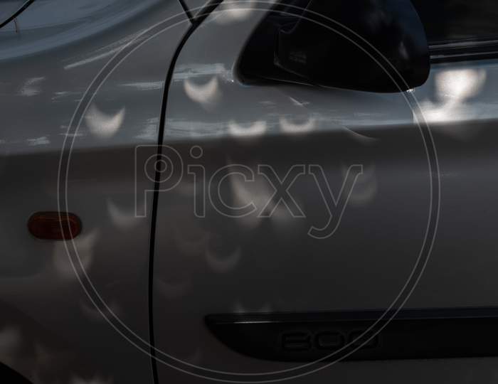 Shadow of leaves visible in Eclipse shape on a Maruti 800 Car