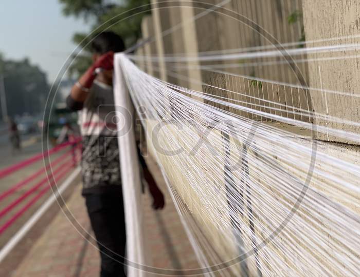 Man making strings for kite festival