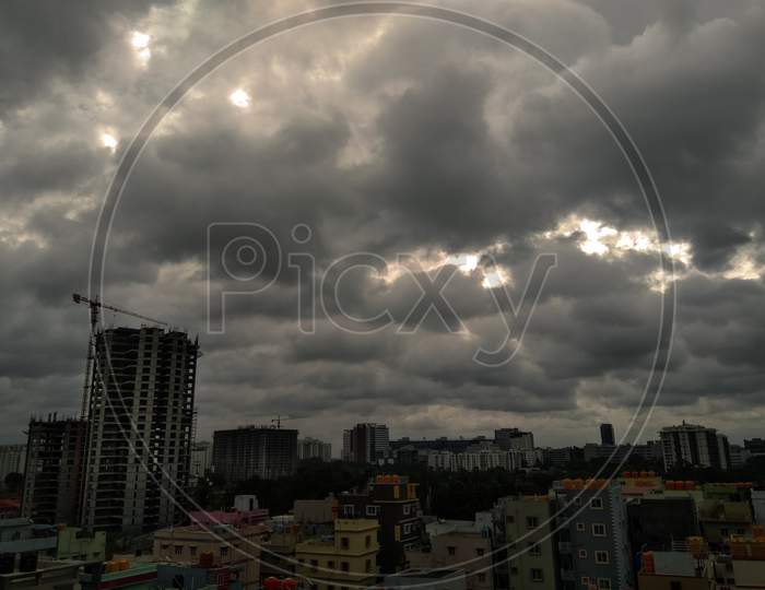 View of Cityscape with Dark Clouds in Sky