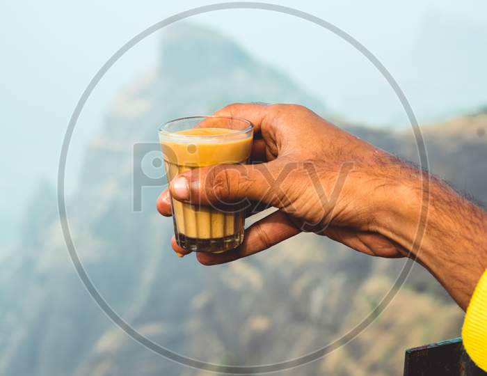 A Man Holding Chai or Tea in Hand