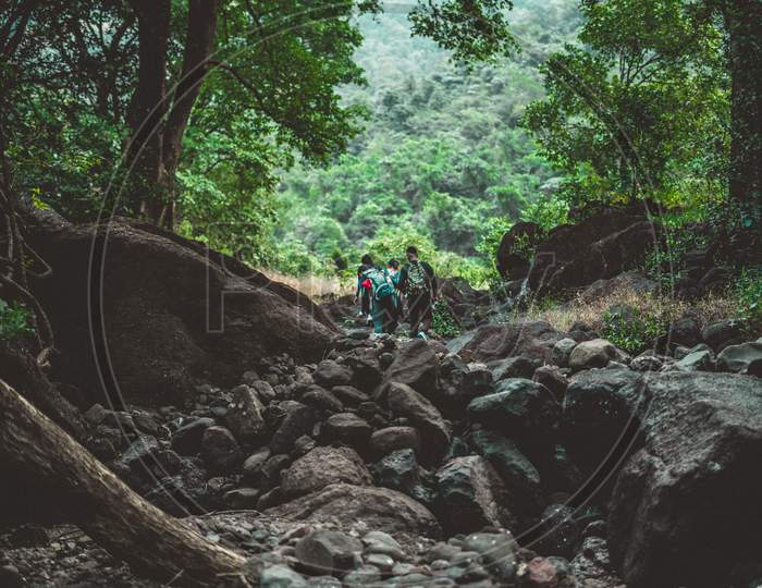 People Trekking a Mountain