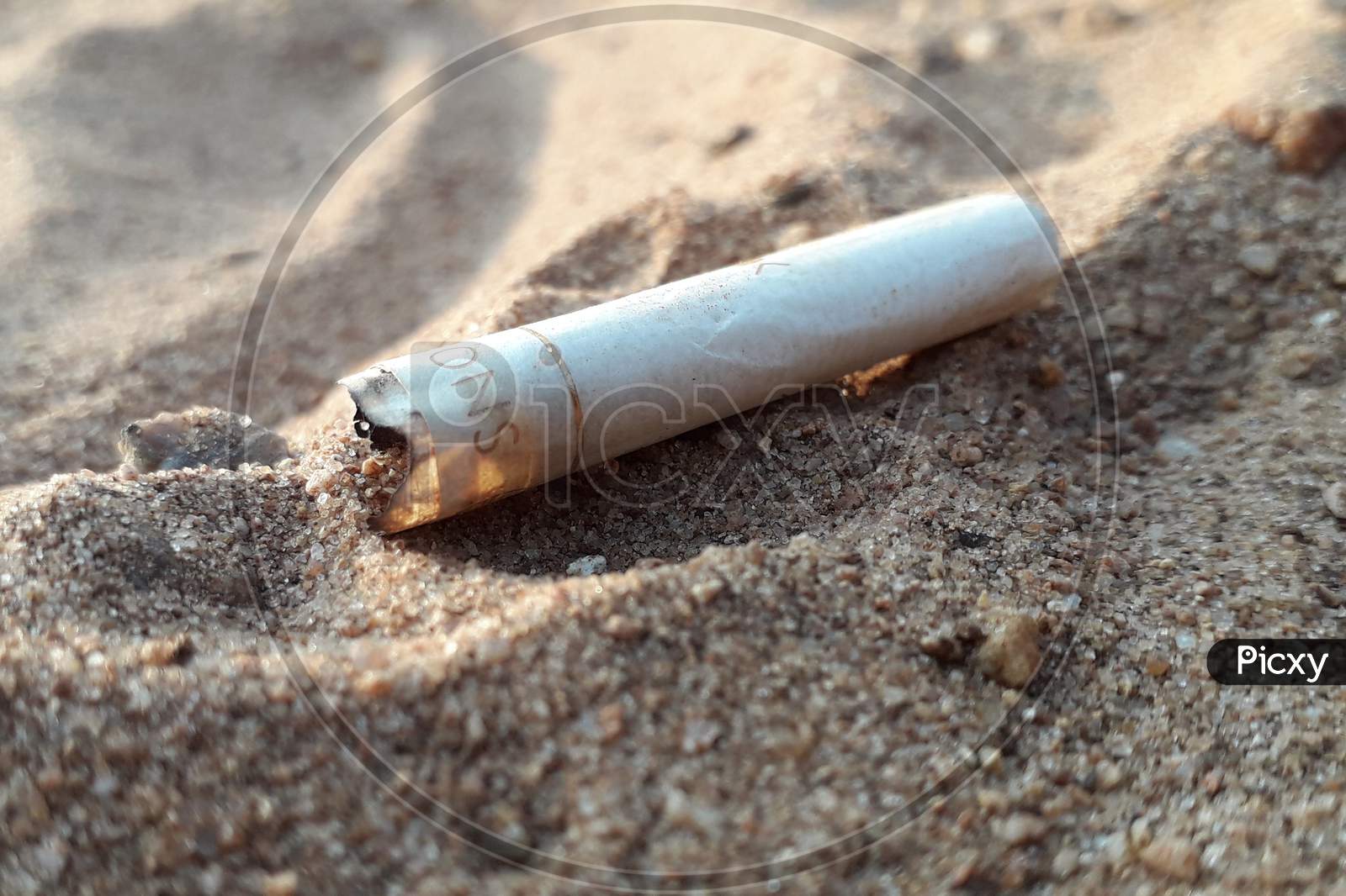 Cigarette Puff On Sand Closeup
