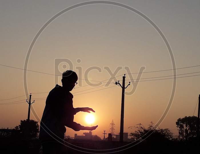 Silhouette Of a Man Over Sun