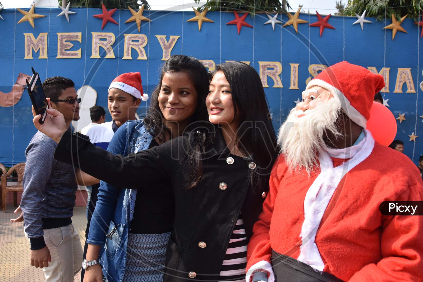 Indian Girls  Taking Selfies At Church During  Christmas  Celebrations in Guwahati