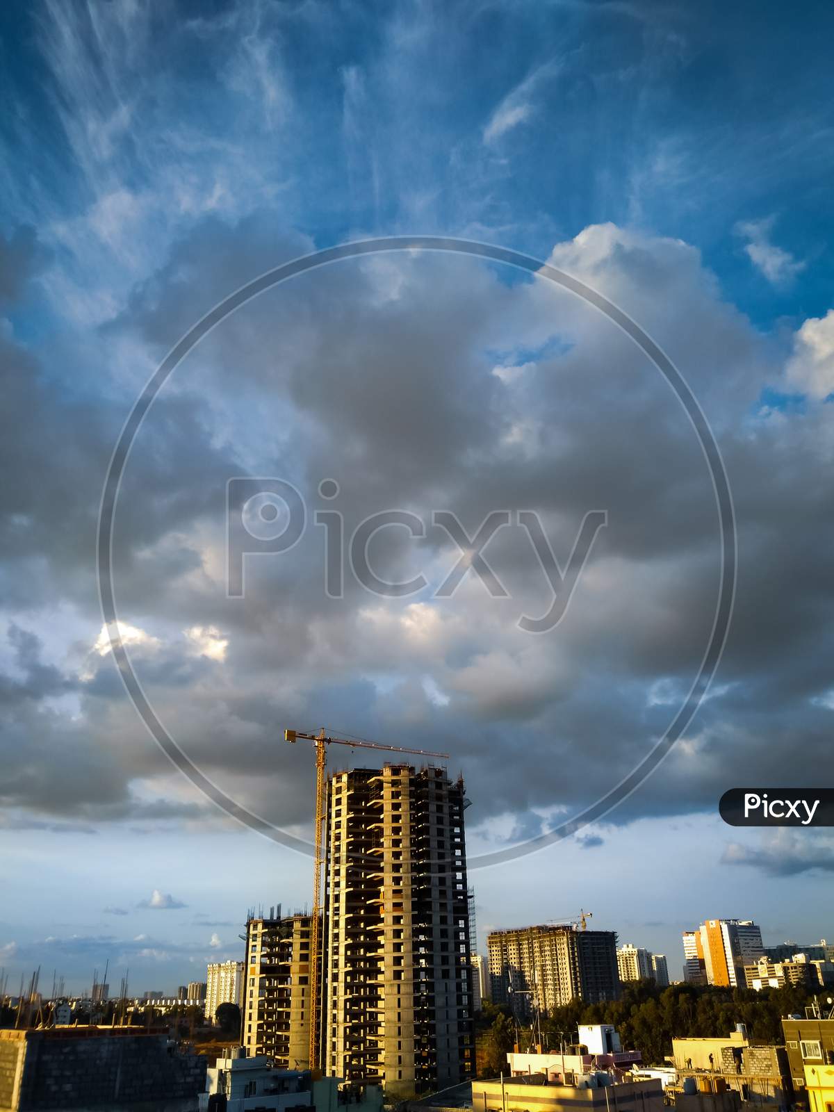 View of High Rise Building Construction with Clouds in Sky Background
