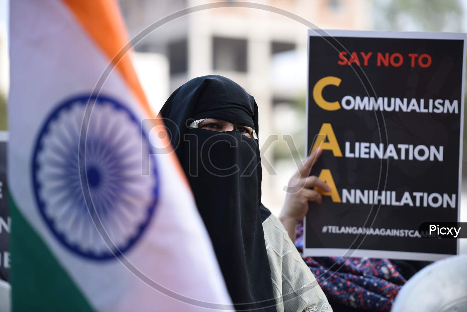 A muslim woman holds Indian Flag at an all women protest against CAA and NRC on 27th December 2019