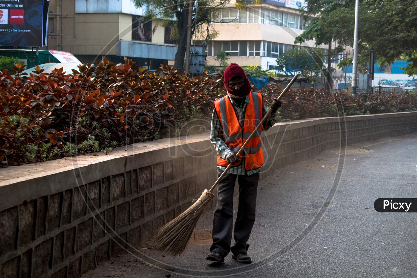A GHMC Sweeper Cleaning Hyderabad City Roads In an Winter Morning