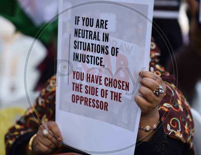 a woman holds a placard at an all women protest against CAA and NRC on 27th December 2019