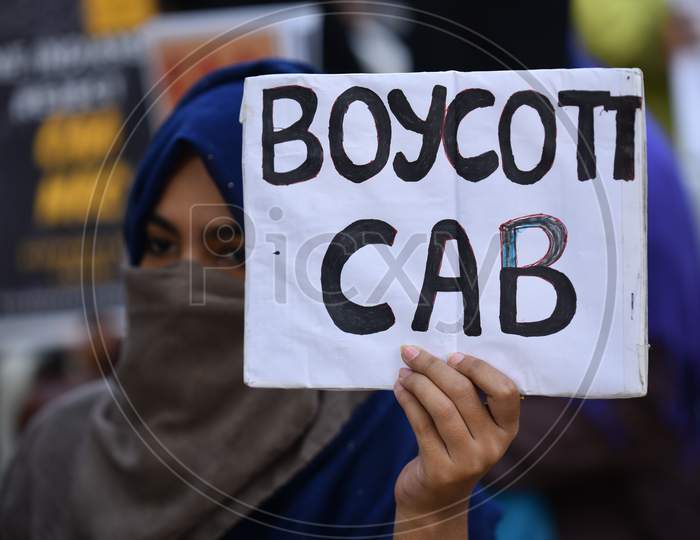 a muslim woman holds a placard at an all women protest against CAA and NRC on 27th December 2019