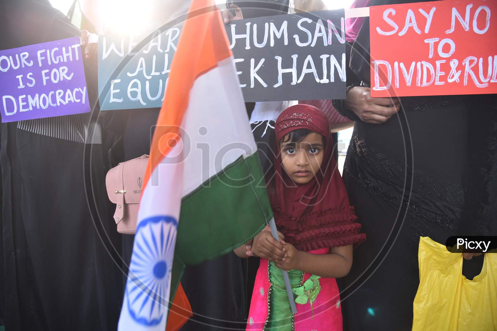 a muslim girl child holds an Indian flag at an all women protest against CAA and NRC on 27th December 2019