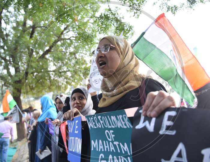 a muslim woman holds a placard at an all women protest against CAA and NRC on 27th December 2019