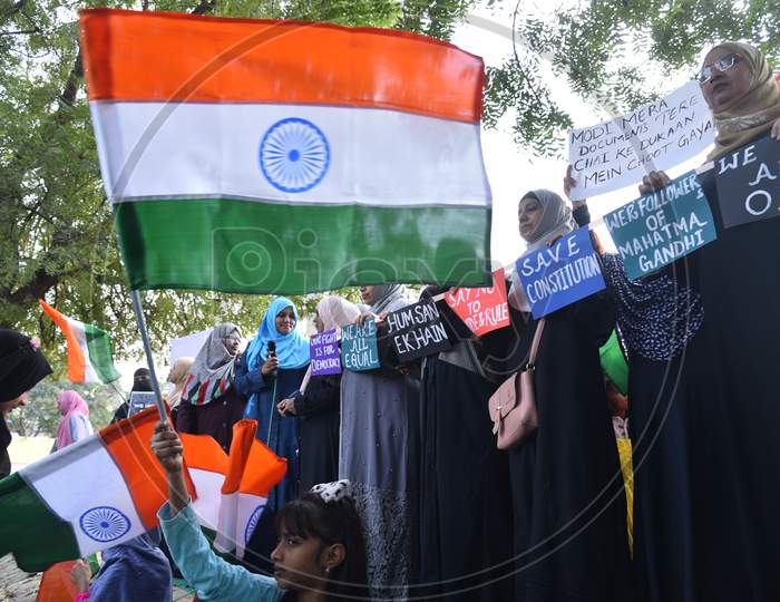 a muslim girl child holds an Indian flag at an all women protest against CAA and NRC on 27th December 2019