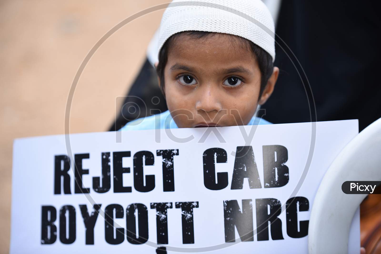 a muslim kid holds a placard at an all women protest against CAA and NRC on 27th December 2019