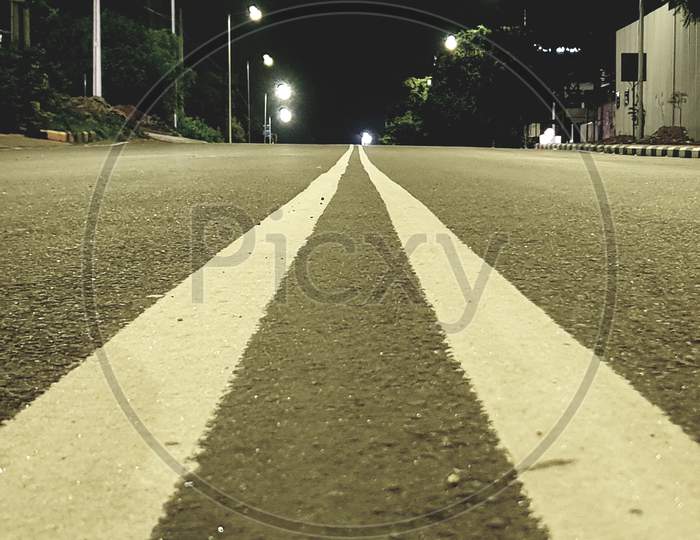 Empty road and street lights