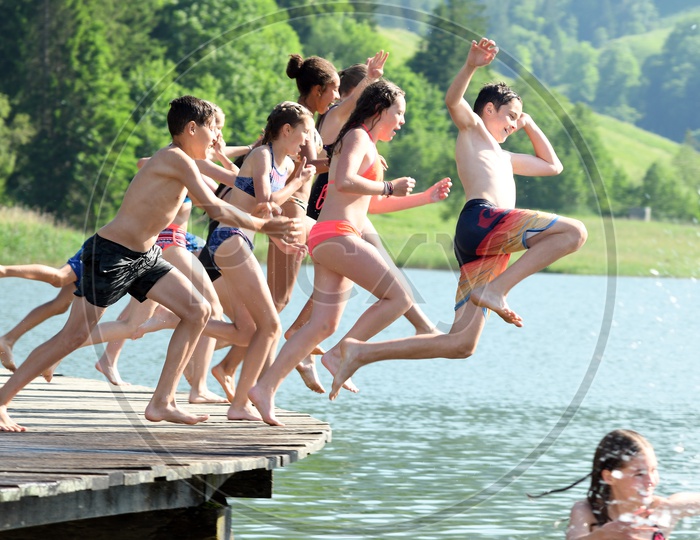 Children Happily jumping in a Lake For Swimming