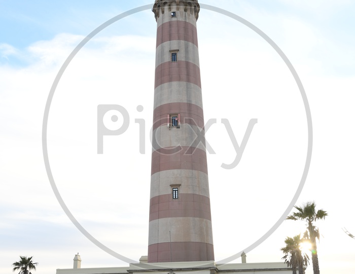 Lighthouse With  Blue Sky Background