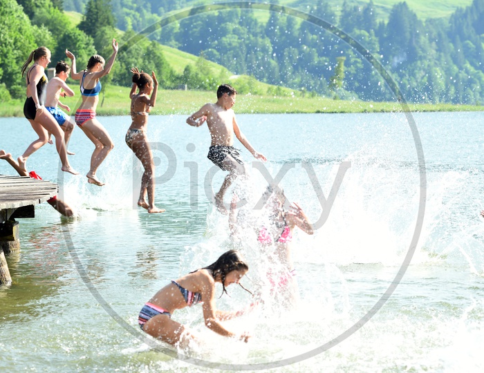 Children Happily jumping in a Lake For Swimming