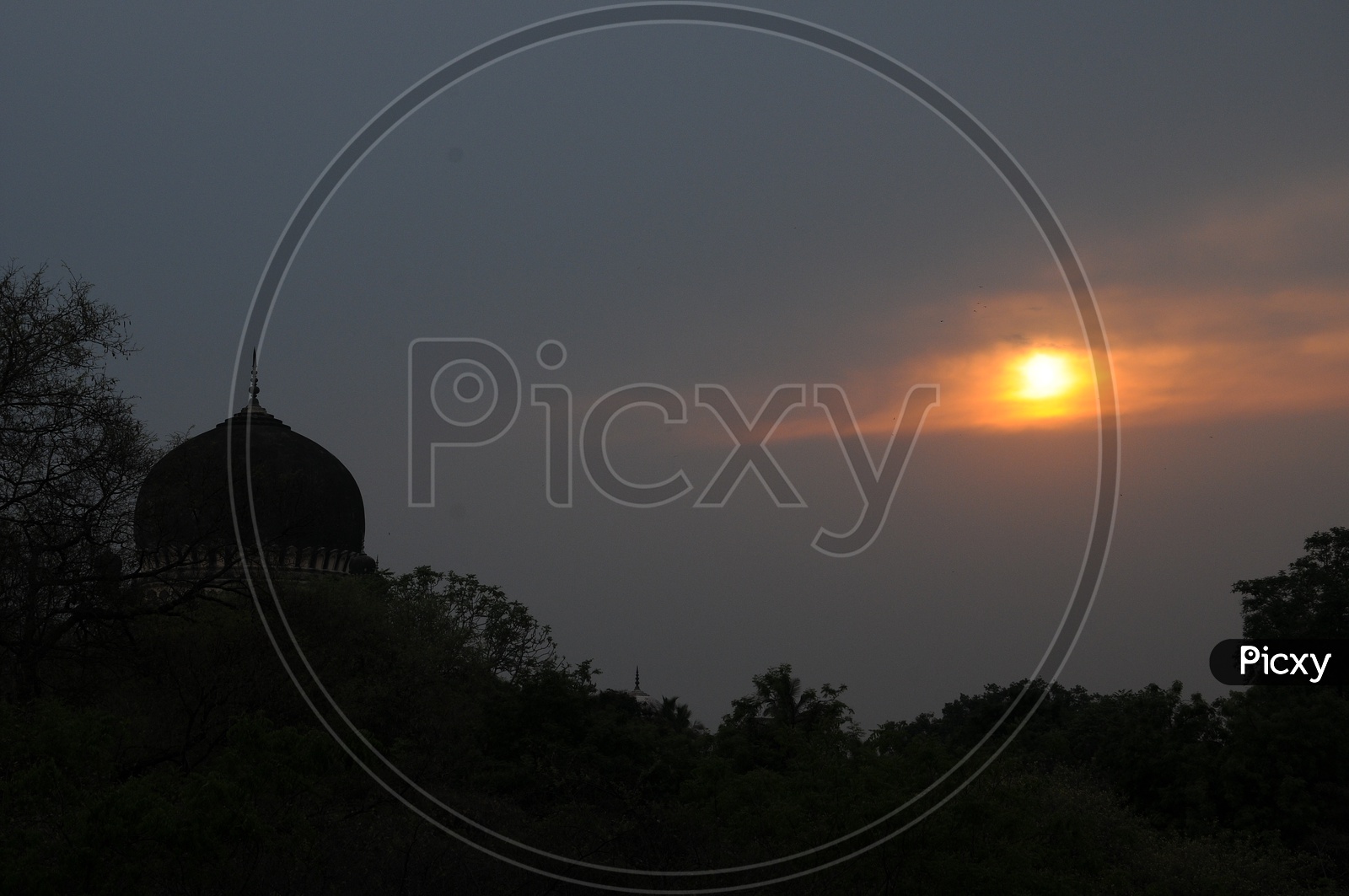 Silhouette Of Qutub Shahi Tombs With a Sunset Sun In Background