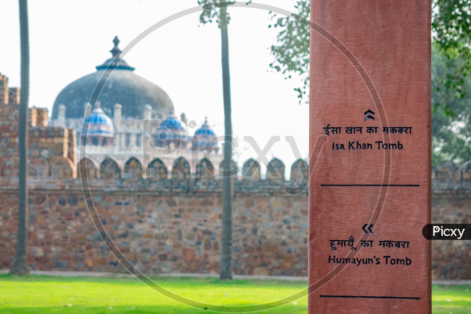 Sign board for Humayun's Tomb and Isa Khan Tomb and Isa Khan Tomb in the background
