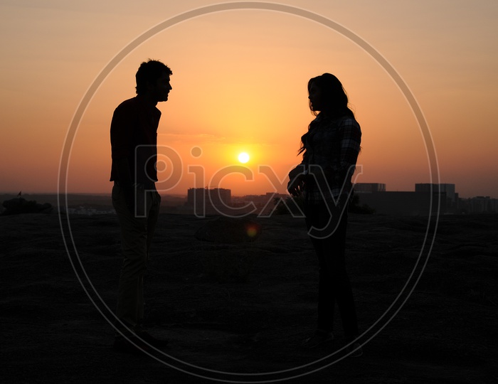 Silhouette Of Couple  Over Sunset Sun in Background