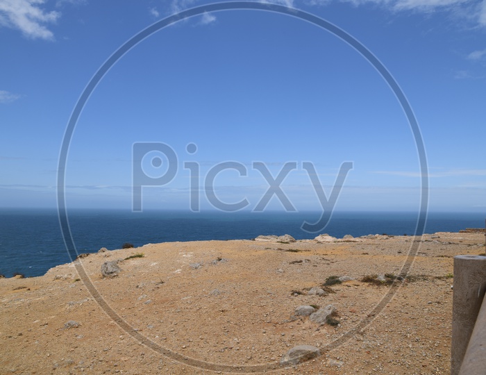 Sea Coast With Hill And Sky Background