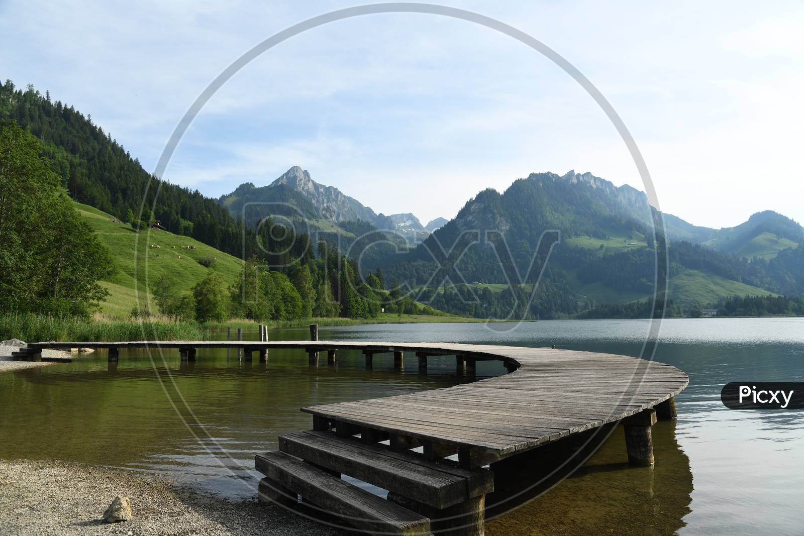 A Wooden Pier on Lake With Swiss Alps in Background