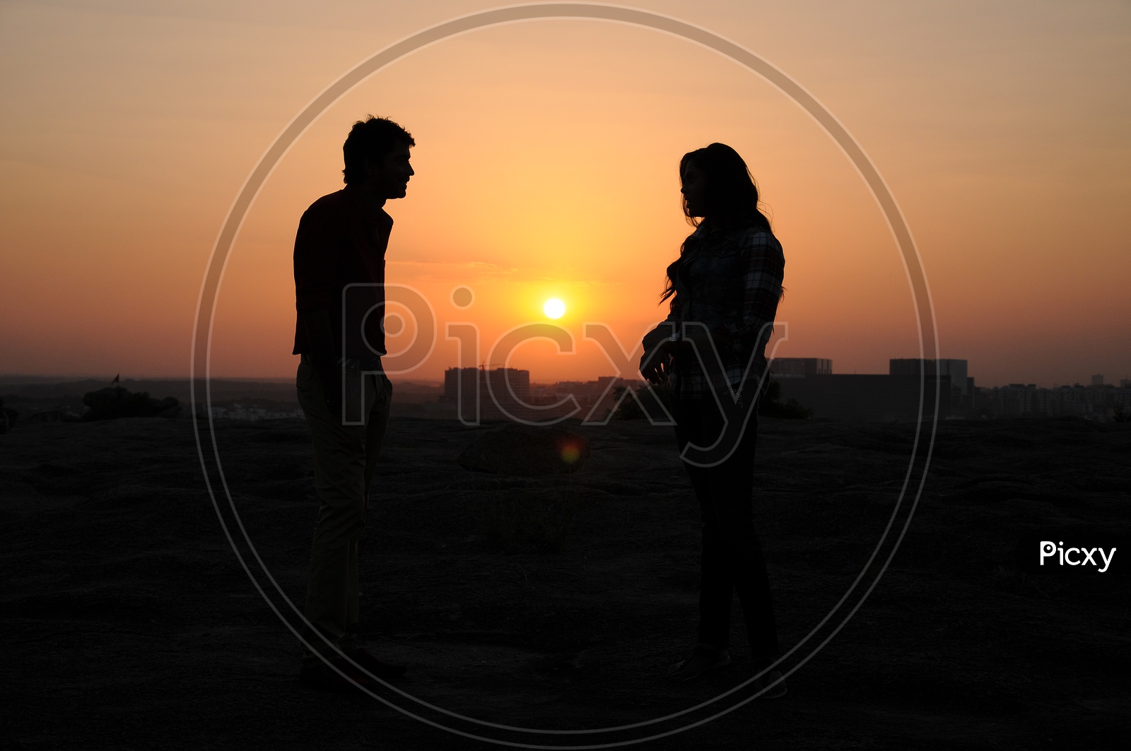 Silhouette Of Couple  Over Sunset Sun in Background