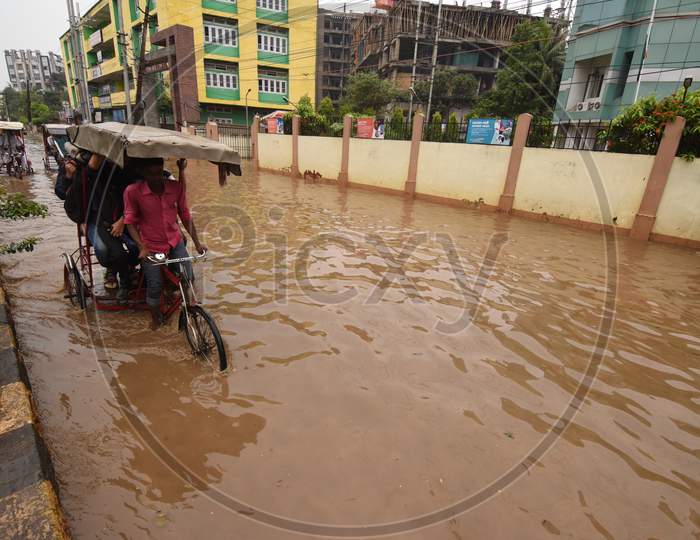 People Of Guwahati On Flooded Roads Due To Seasonal Floods In Assam