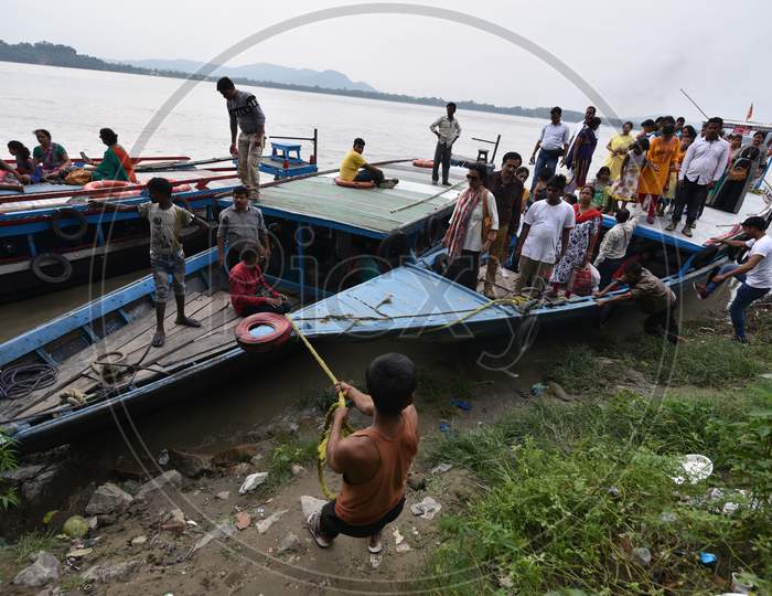 People of Guwahati and Surrounding Villages Commuting on Boats Over  Bramahaputra River As a Part Of Their Daily Life Style
