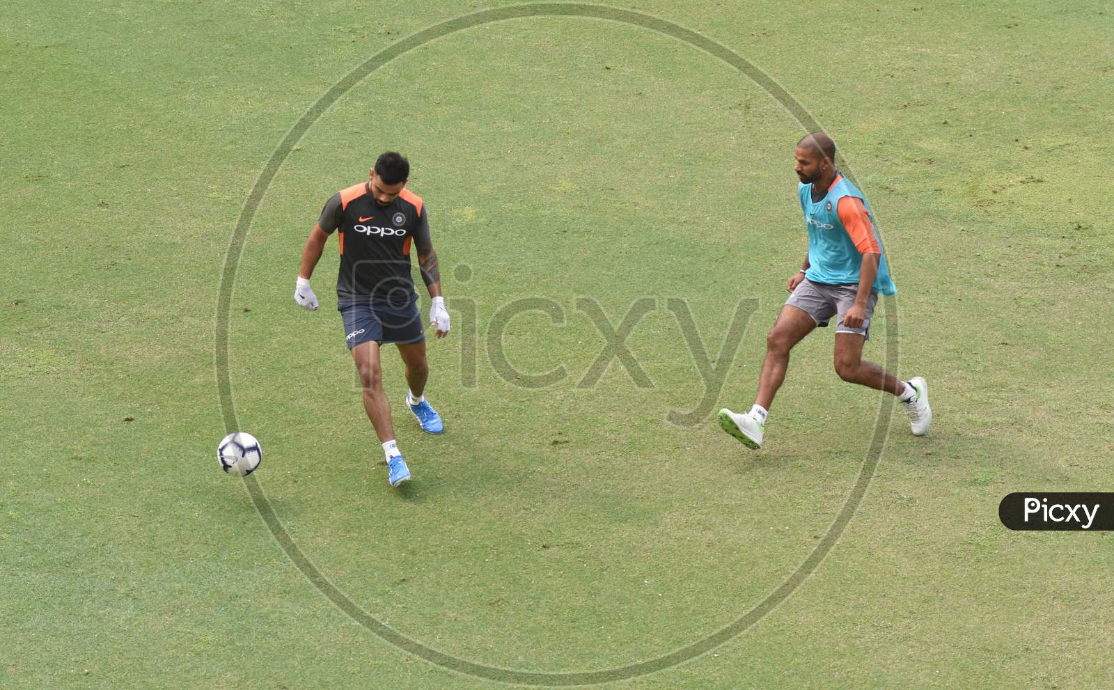 Team India Captain  Virat Kohli  And Sekhar Dhawan Plays Football During A Practice Session Ahead Of The First One Day International Cricket Match Against West Indies, At Aca Cricket Stadium, Barsapara In Guwahati