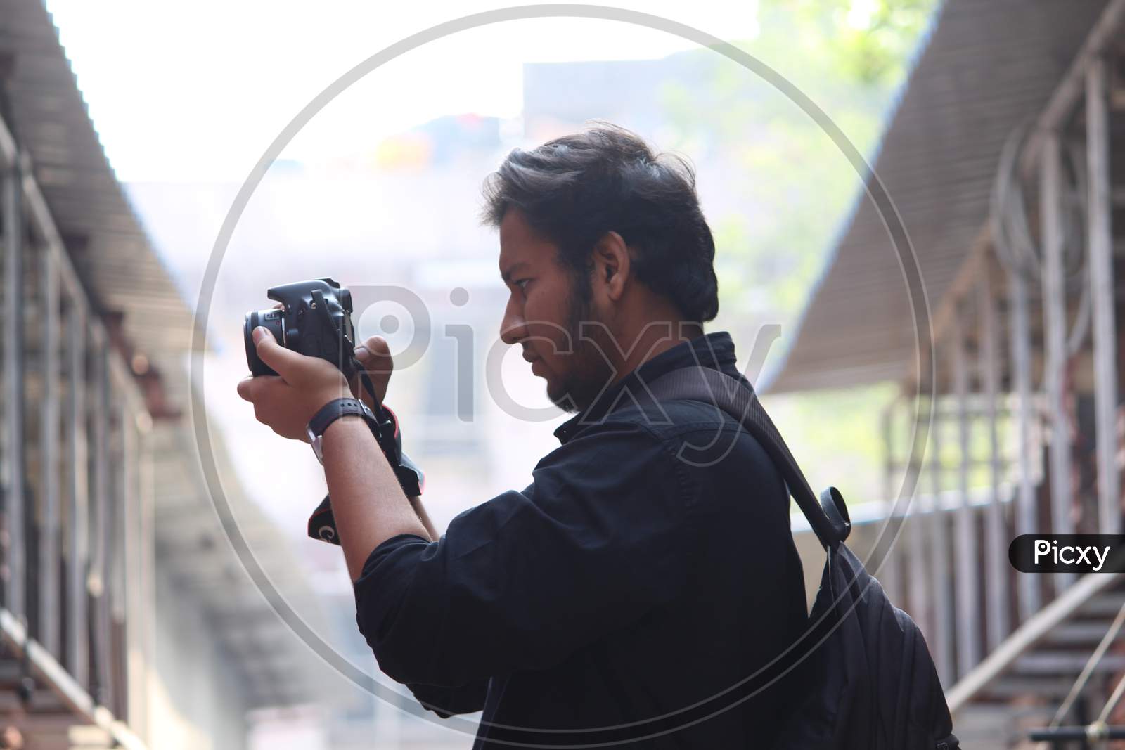 A Photographer Shooting With DSLR Camera