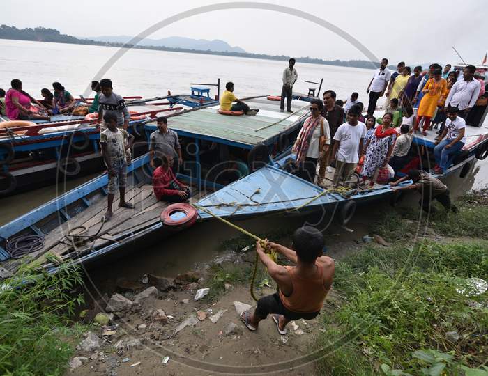 People of Guwahati and Surrounding Villages Commuting on Boats Over  Bramahaputra River As a Part Og Their Daily Life Style