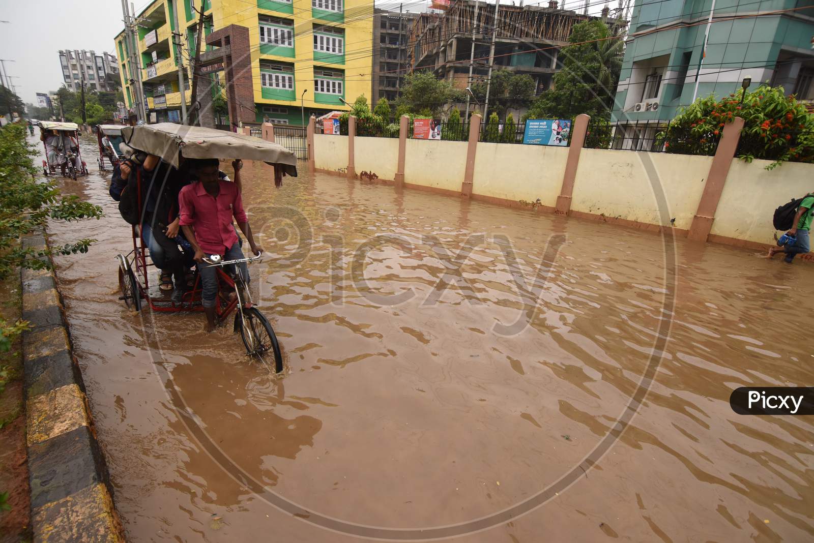 People Of Guwahati On Flooded Roads Due To Seasonal Floods In Assam