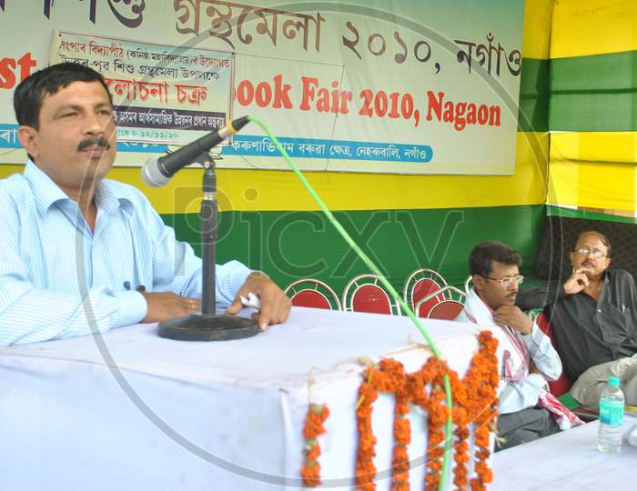 Dignitaries Speaking on Dias At a Book Fair