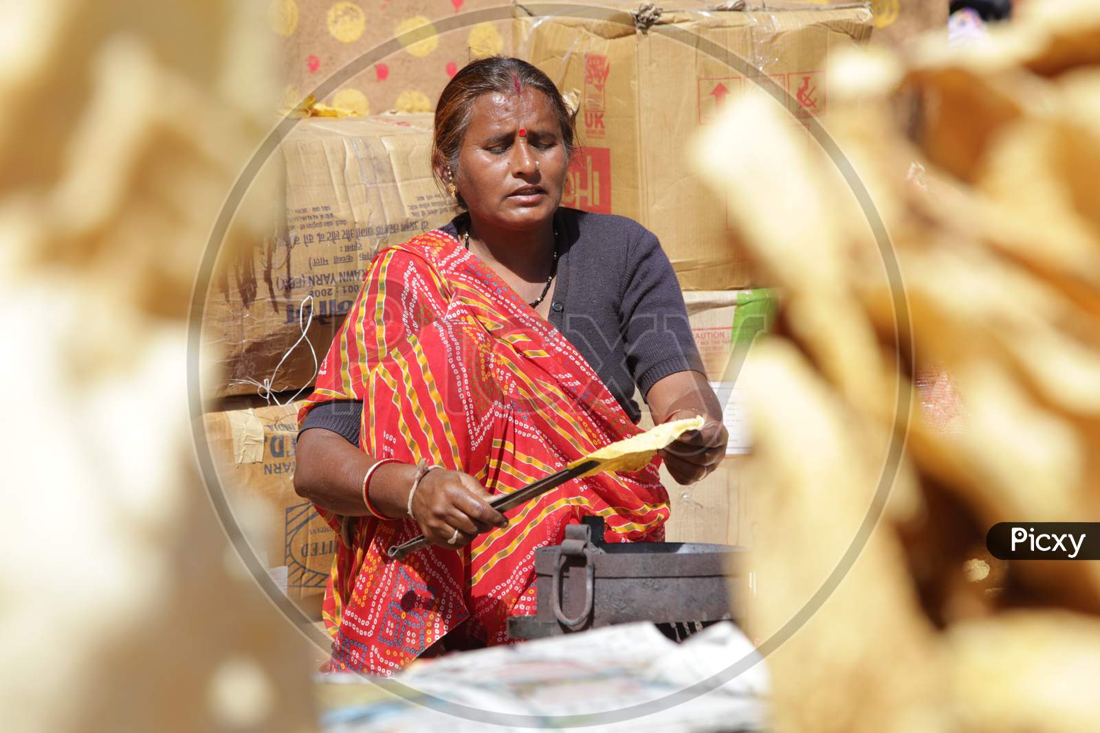 Rajasthani Woman Preparing Roti's in Shilpgram Fair, Udaipur, Rajasthan