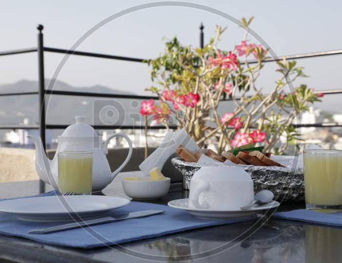 Teapot and Breakfast on Table in a Restaurant, Udaipur
